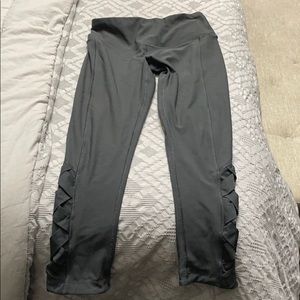 dark green/gray leggings with cross on side